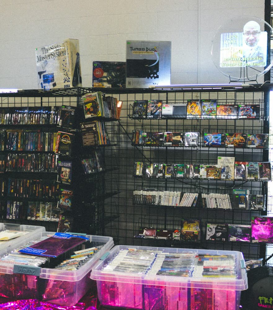 Wall racks and clear storage bins of collectibles inside a hobby shop